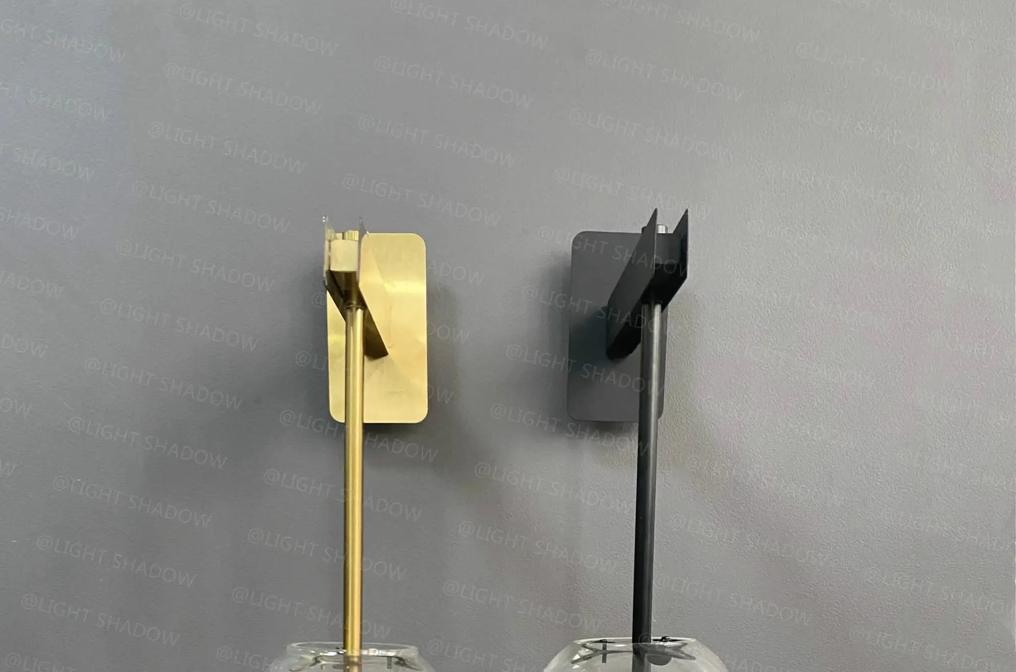 Modern glass wall light sconces in brass gold and matte black finishes; pair of decorative bedside lamps.
