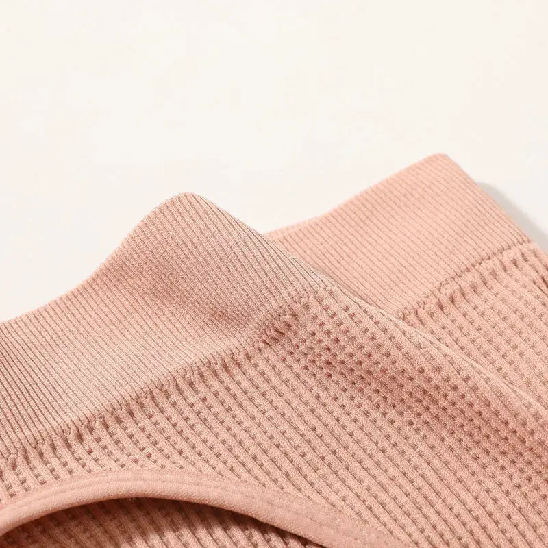 Women seamless ribbed bralette close-up in soft pink fabric
