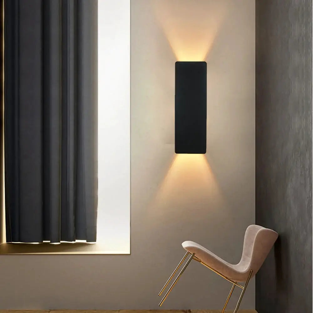 Modern LED indoor wall lamp by Simples Market, aluminum black finish with upward and downward glow.