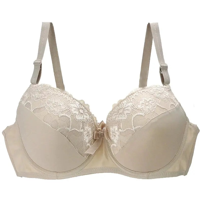 Nouvelle seamless plus-size unlined bra in beige with lace cups and bow, underwire support.