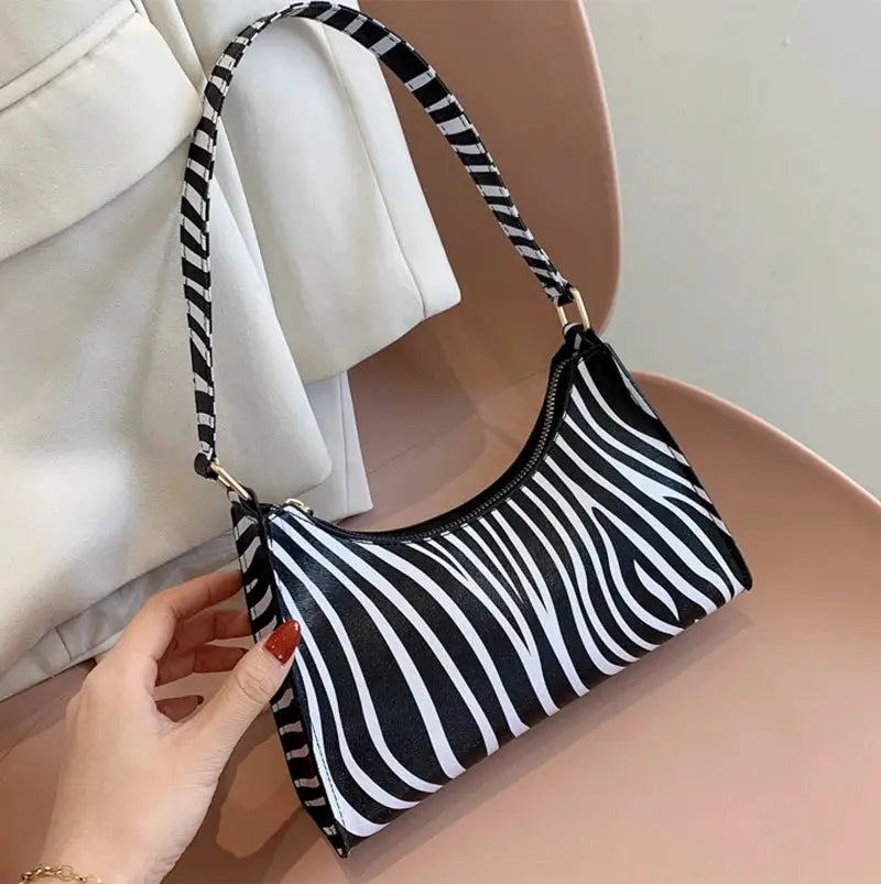 Zebra print PU leather shoulder bag with black-and-white stripes and gold hardware
