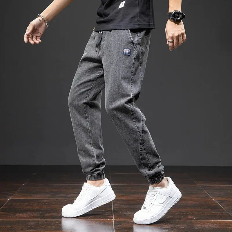Men's gray denim cargo jogger pants with drawstring waist and elastic cuffs