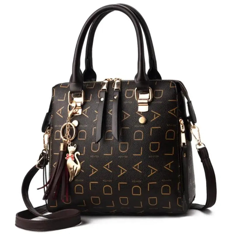 Simples Market PU leather handbag with top handles, crossbody strap, black with gold letter pattern and tassel charm