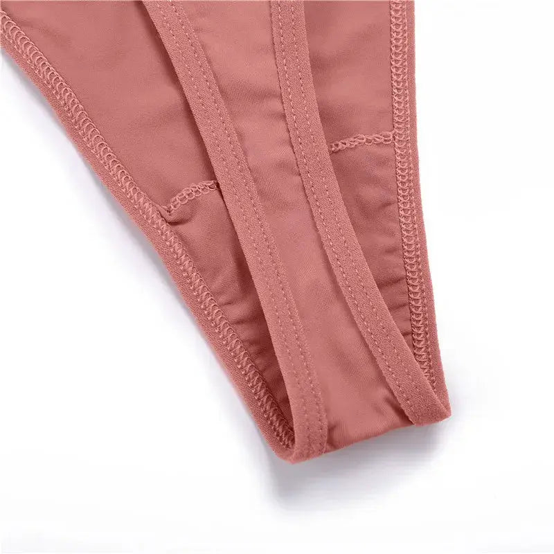 Pink low-rise thong underwear close-up with stitched edges and T-back design