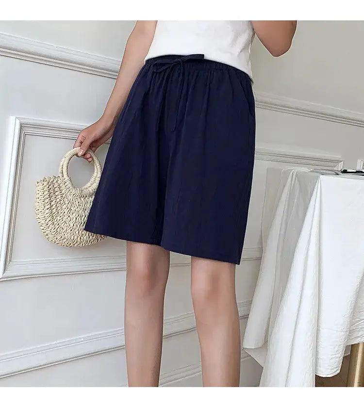 Women's navy cotton shorts with high waist, drawstring, and two pockets