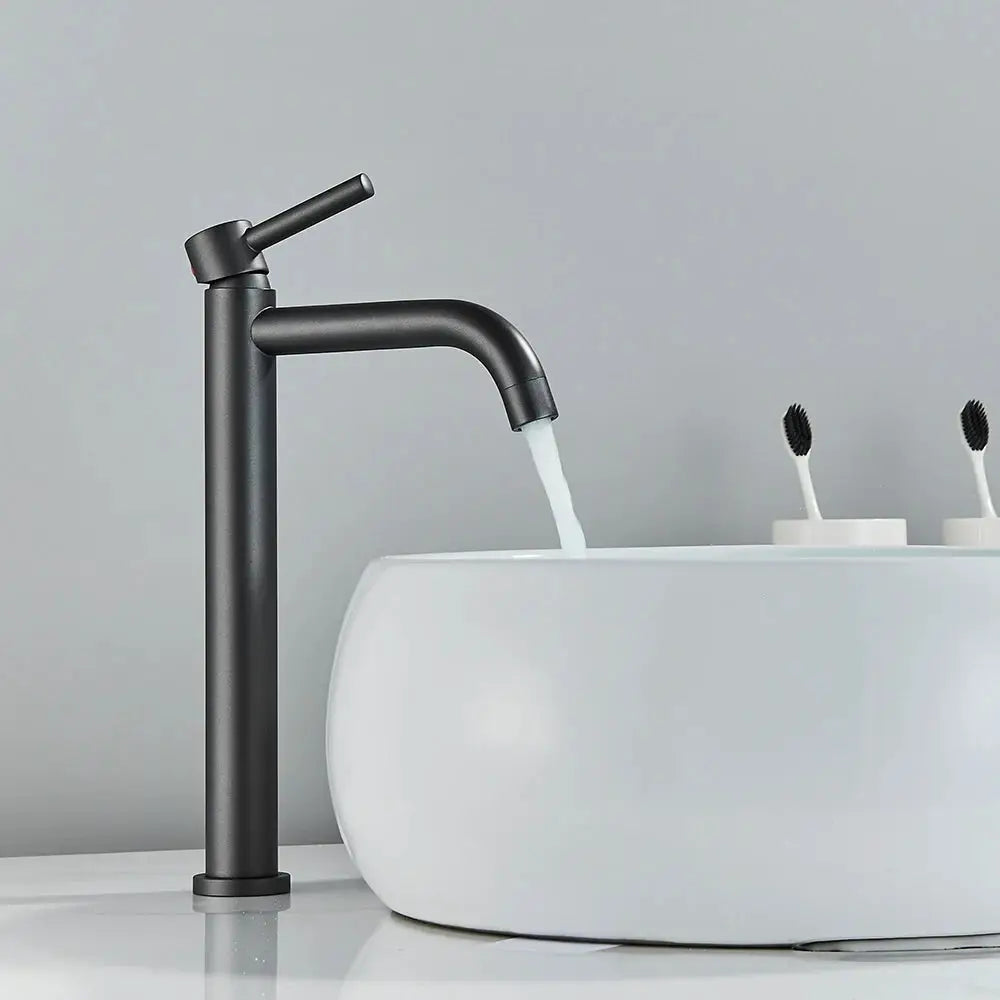 Black matte basin faucet with a single lever over a white ceramic bathroom basin.