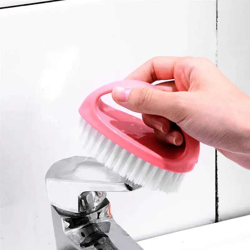 Pink egg-shaped cleaning brush with white bristles for bathroom cleaning