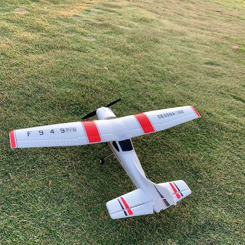 RC airplane WLtoys F949 LCD version, Cessna 182 replica, white with red bands on grass