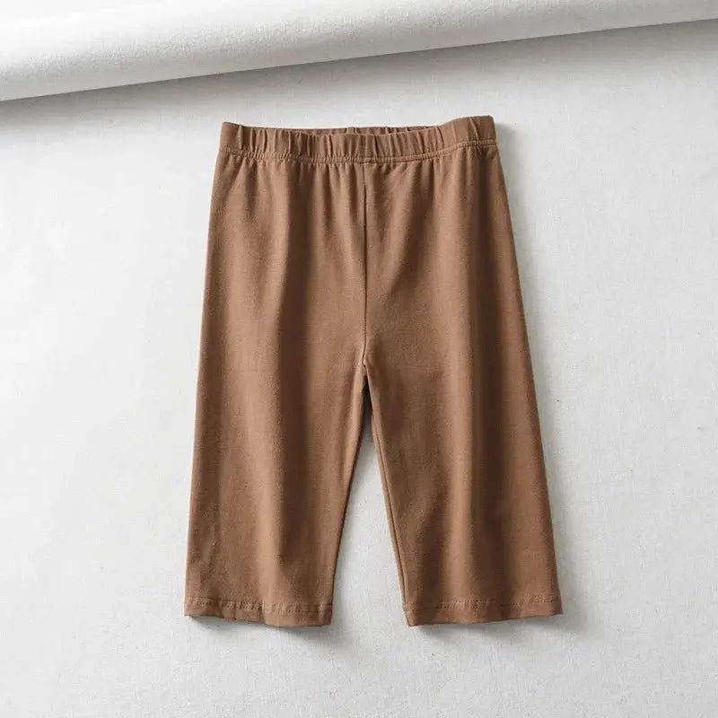 Biker shorts for women, brown solid, high-waist elastic, knee-length.