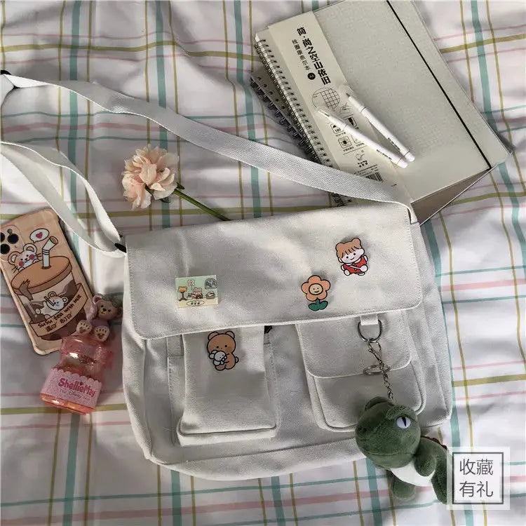 Simples Market women's canvas messenger bag in white with cute cartoon patches and adjustable shoulder strap
