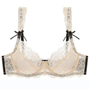 Nude lace push-up bra with black bow straps and sheer mesh panels
