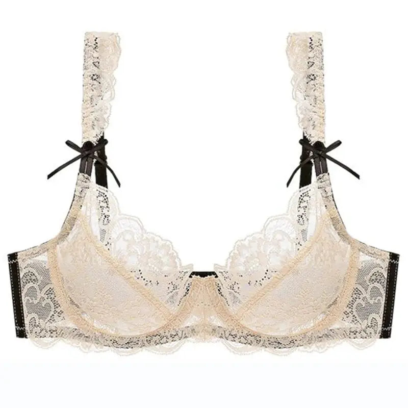 Nude lace push-up bra with black bow straps and sheer mesh panels