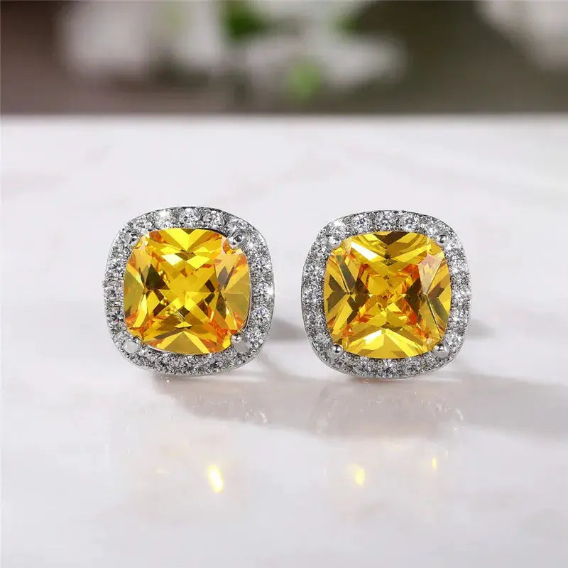 Huitan cushion-shape stud earrings in silver with yellow cubic zirconia and a halo of clear stones.