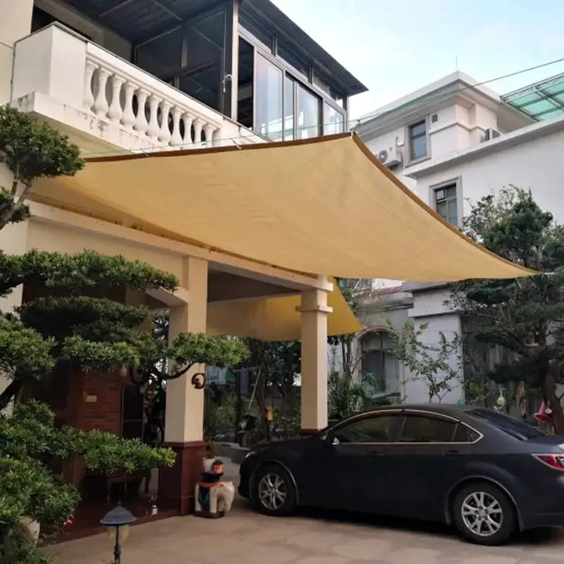 Tewango sun shade sail, 95% anti-UV HDPE, beige canopy over driveway carport for shade.