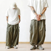 Men's oversized olive cargo pants with multiple pockets and a baggy wide-leg silhouette