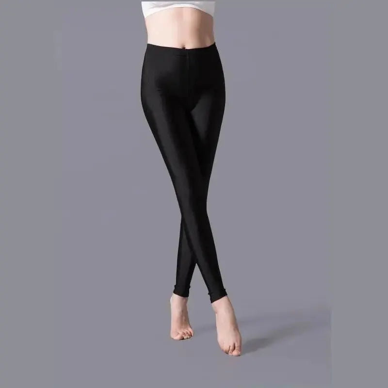 Shiny black women’s leggings with stretchy spandex fabric for casual wear