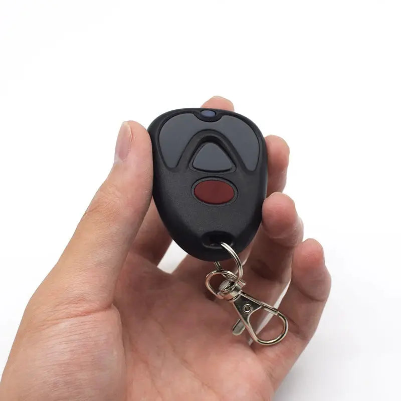 Garage door remote control, black handheld with red button, 433MHz fixed code on key ring.