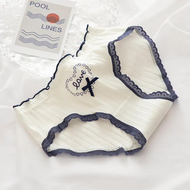 Cotton women's underwear briefs in white with navy lace trim and bow detail