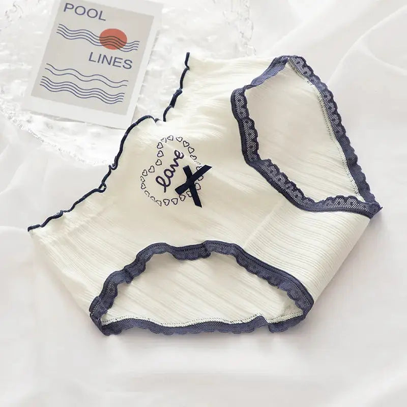 Cotton women's mid-rise underwear in white with navy lace trim and bow detail