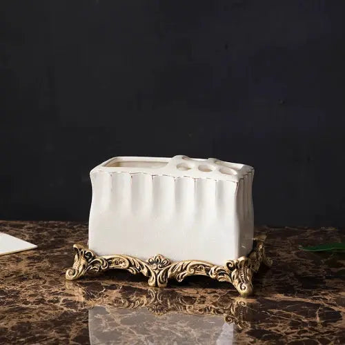 Simples Market European-style white ceramic toothbrush holder with ornate gold-tone base, part of a five-piece bathroom set
