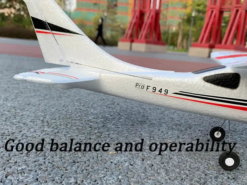WLtoys F949 LCD RC airplane, white fixed-wing model with red and black stripes.