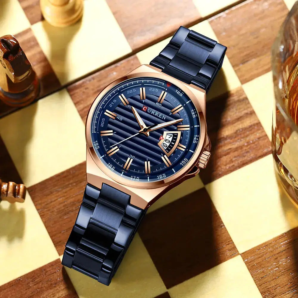 Curren men's luxury watch with rose-gold stainless steel case, blue dial with date window, and blue steel band.
