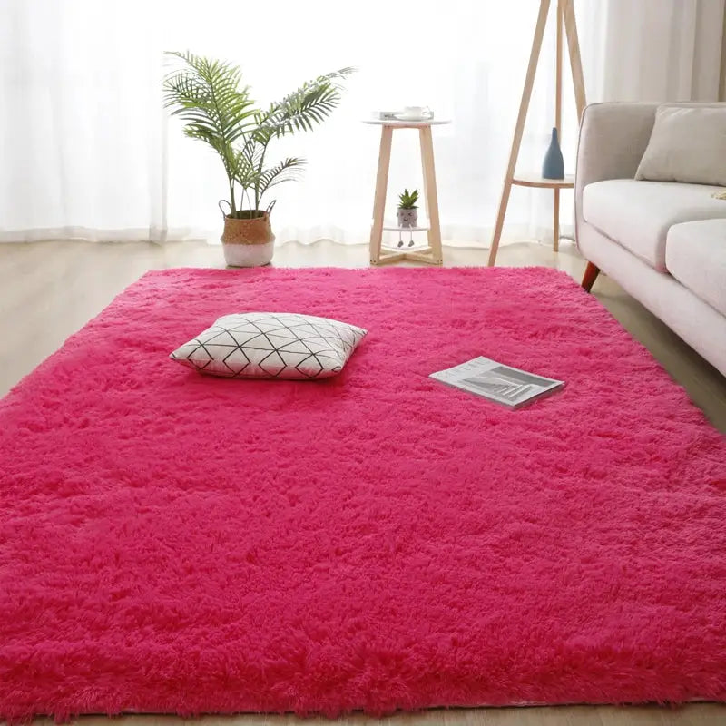 Pink fluffy long-pile shag rug 160x230 cm for living room, bright natural light, with sofa and plants