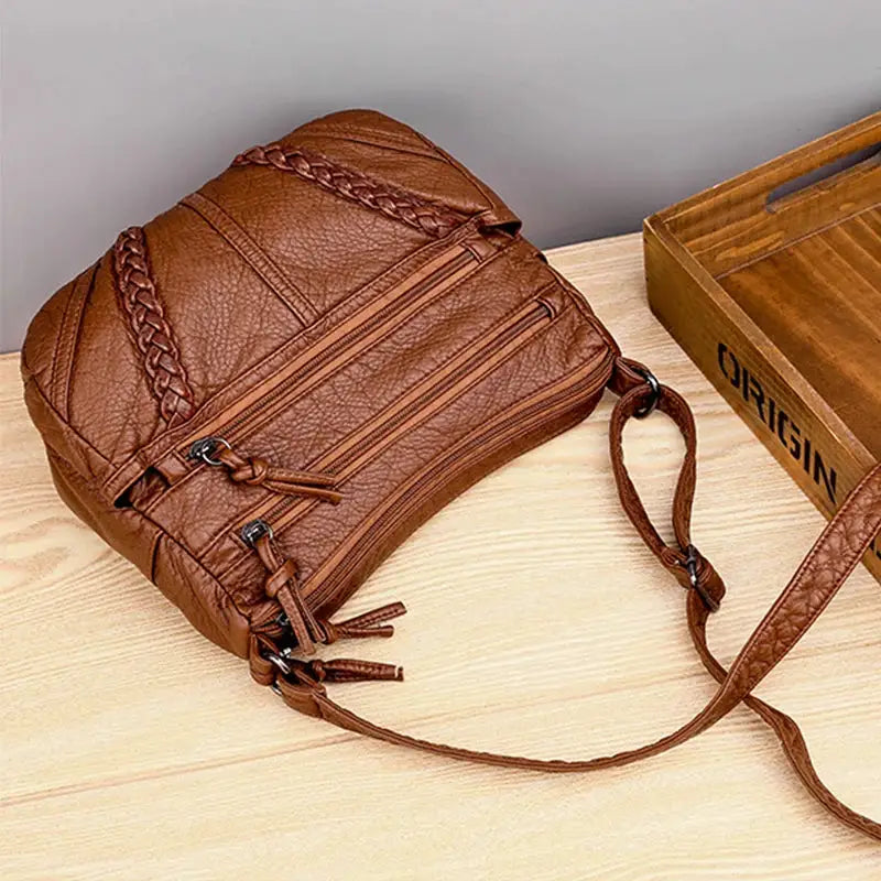 Top selling women messenger bag by Simples Market; brown PU leather-look with braided handles and multiple zip pockets.