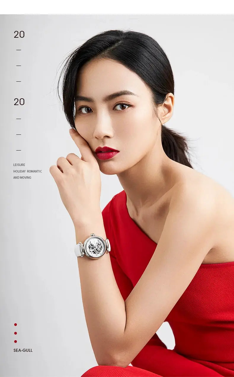 Sea-Gull women's skeleton automatic watch with white leather strap worn by model in a red dress