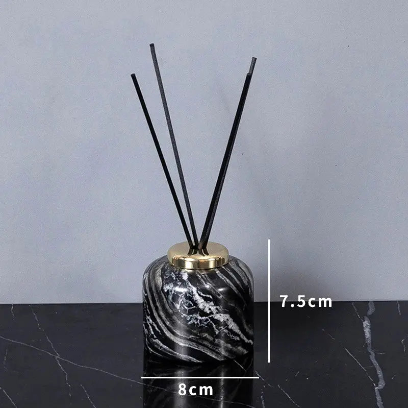 Simples Market marble bathroom diffuser with black natural marble finish, gold cap, and reed sticks