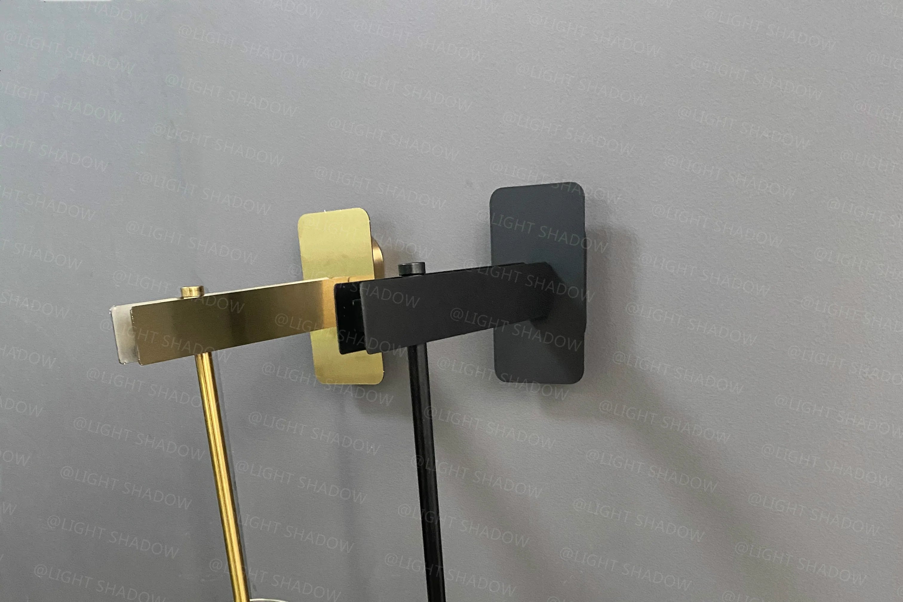 Modern wall light sconce with black backplate and gold arm, LED bedside lamp.