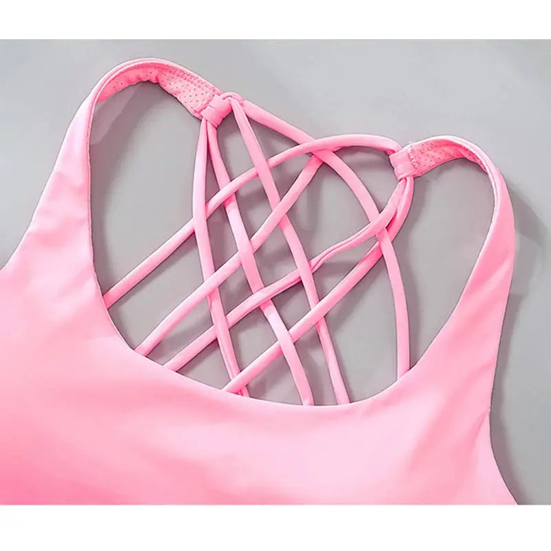 Pink women's fitness sports bra with cross-back lattice straps