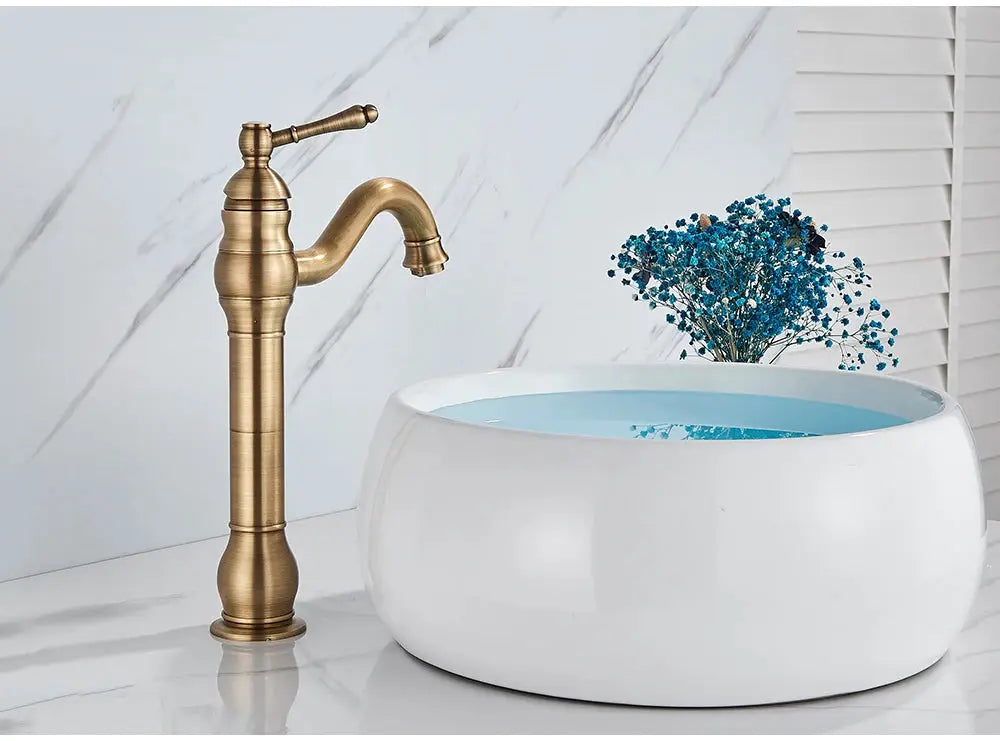 Antique brass vessel sink faucet; deck-mounted, single-hole hot/cold mixer.