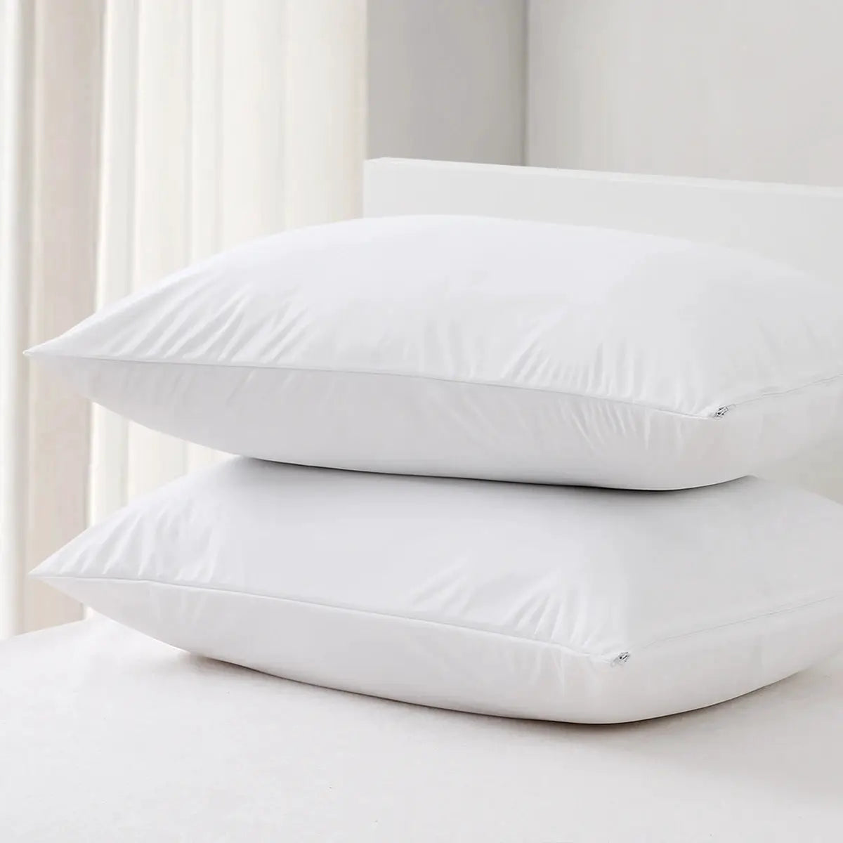 Smooth waterproof white pillow covers with zippers; two pillows shown.