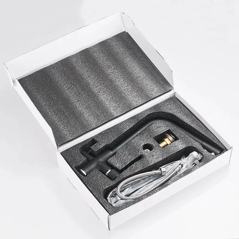 Simples Market black kitchen faucet with dual swivel spout and hoses in foam packaging