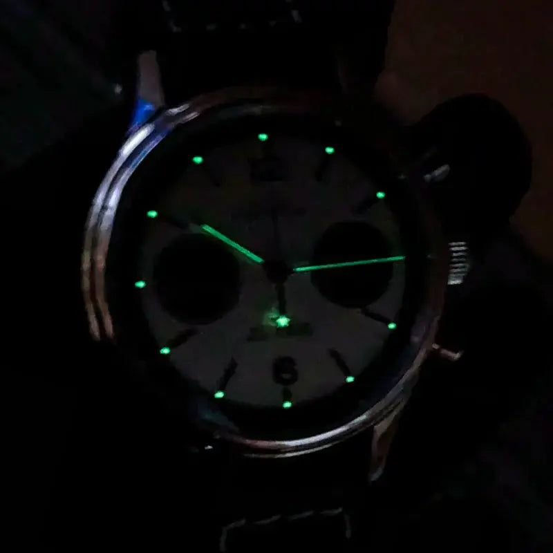 Pilot panda chronograph watch with green lume markers and hands, leather strap