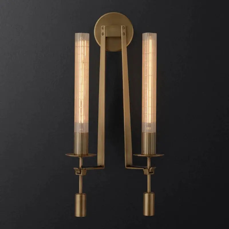 Copper wall sconce with two glass cylinder shades and circular backplate, warm ambient lighting