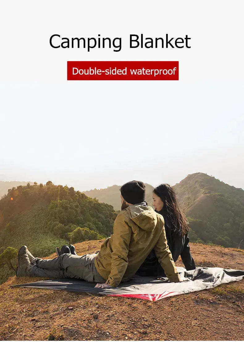 Naturehike picnic blanket on a hillside with a couple sitting; gray fabric with red edge, double-sided waterproof.