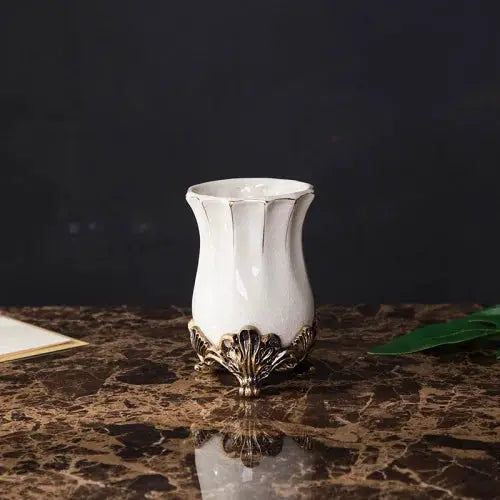 White ceramic bathroom tumbler with ornate bronze base for European style decor