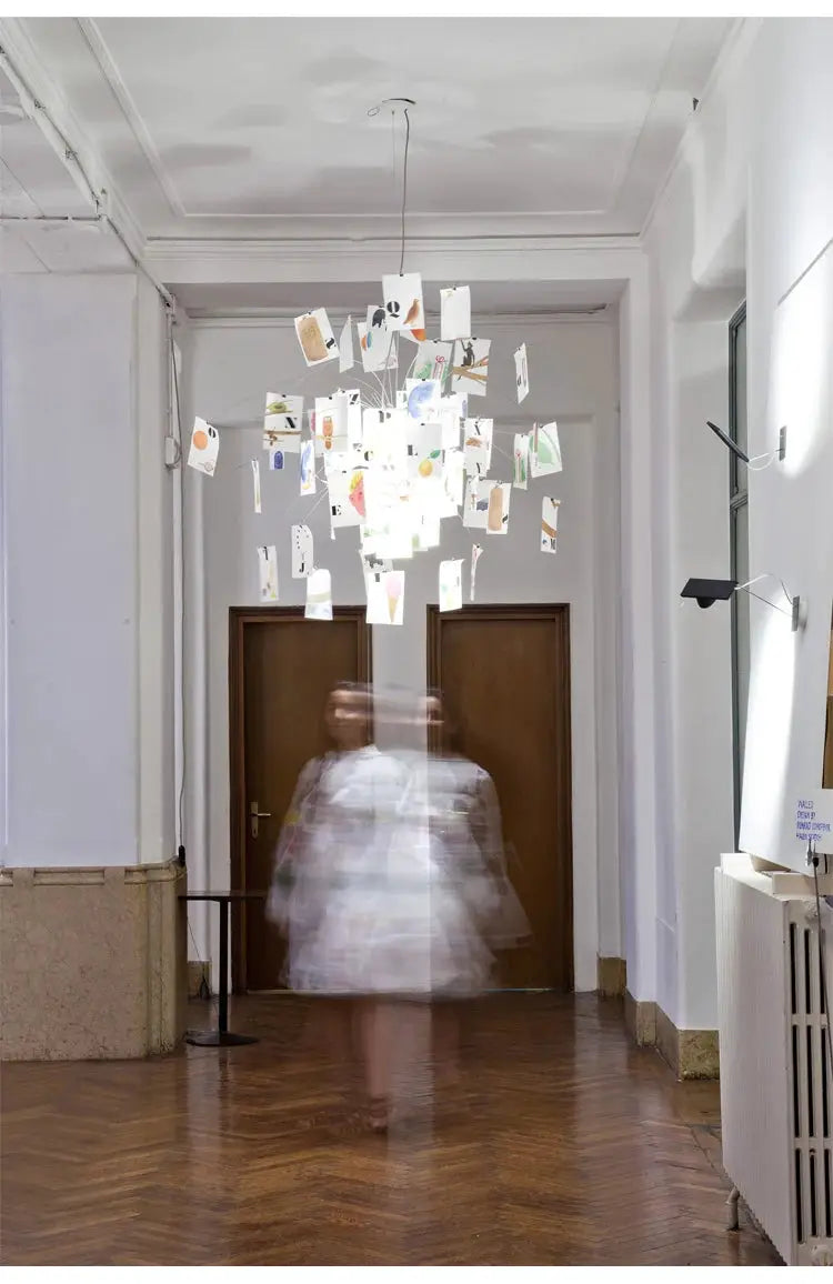 Ingo Maurer replica colored paper chandelier with LED E27, hanging in a bright living room.