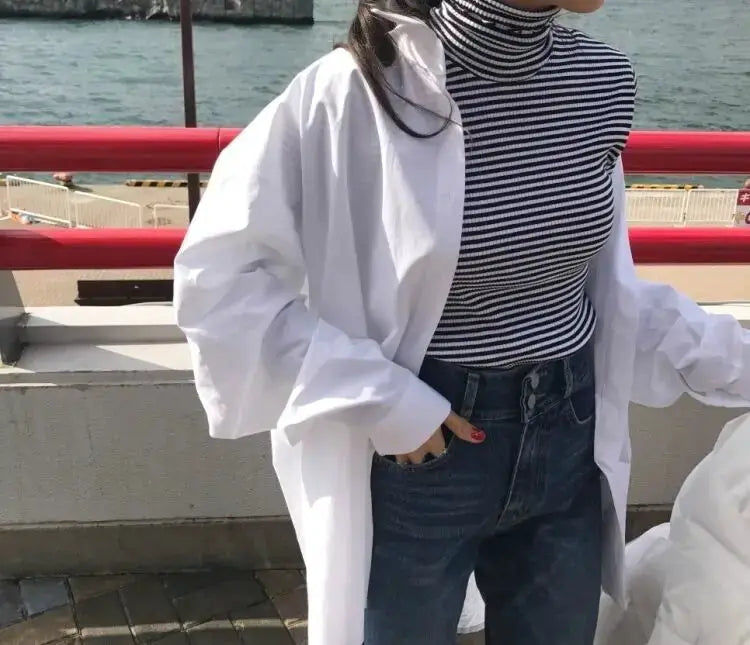 Zadily white oversized button-up shirt, long sleeves, worn over a striped turtleneck and jeans