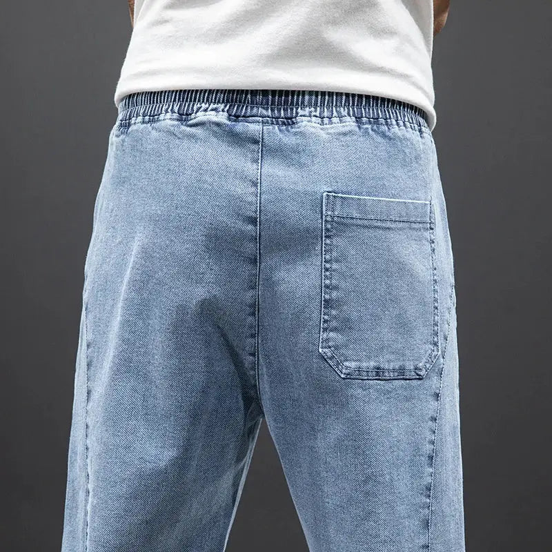 Men's blue denim cargo jogger jeans with elastic waistband and back pocket