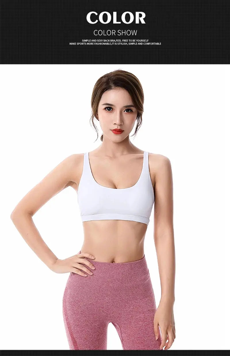 White fitness sports bra and pink leggings, two-piece set with wide straps.