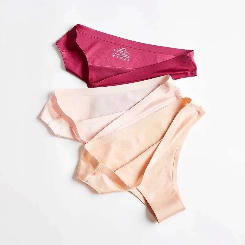 Women's Simples Market seamless thong underwear set of three in ice silk, magenta, blush pink, and peach.
