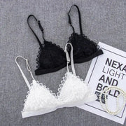 Two lace bralettes in black and white with adjustable straps; wire-free, triangle lace cups.
