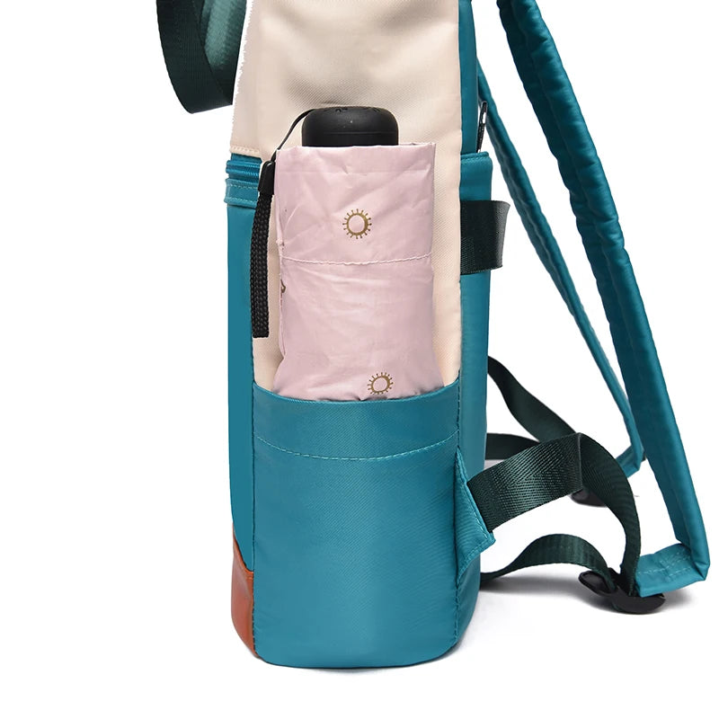 Women's teal waterproof Oxford backpack with beige trim and side pocket holding pink water bottle