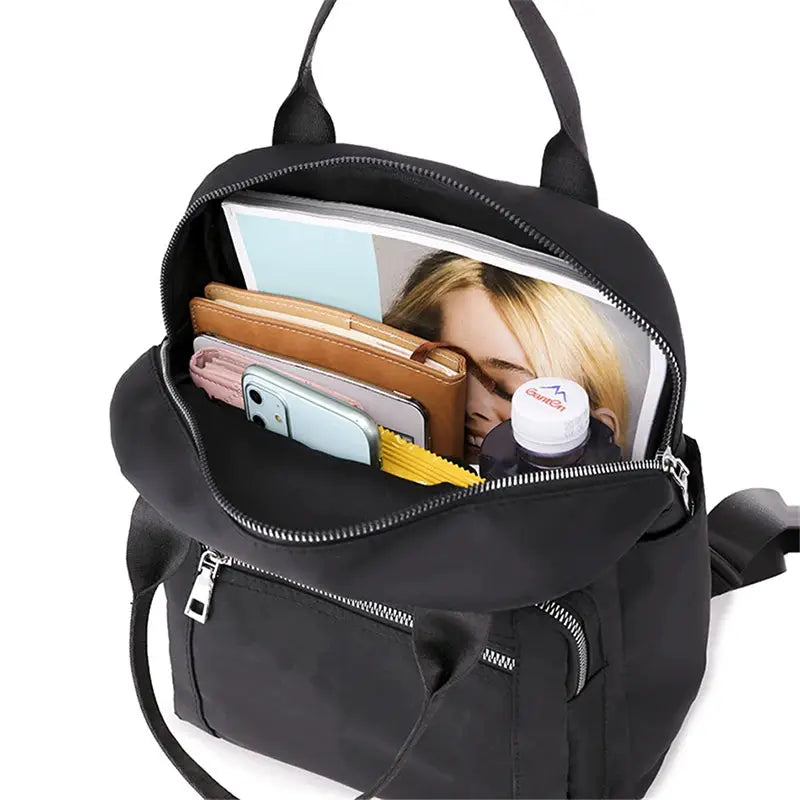 Women's black waterproof Oxford backpack by Simples Market, large-capacity travel bag opened to show phone and wallet.