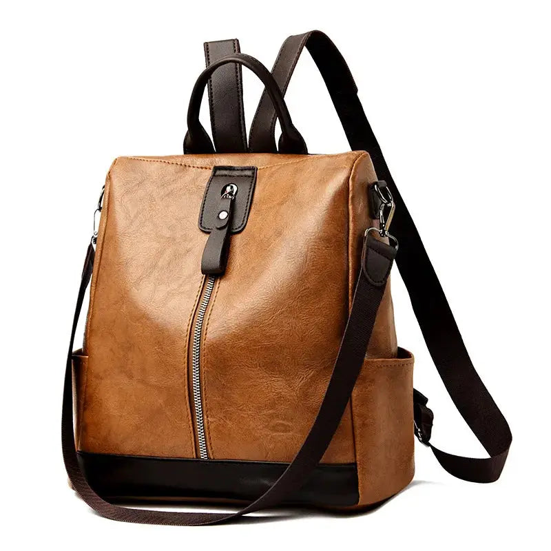 Brown PU leather anti-theft backpack with black bottom, vertical front zipper, top handles and shoulder strap