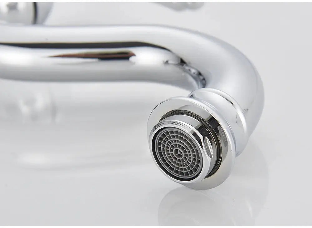 Chrome deck-mounted basin vessel faucet with a curved gooseneck spout and round aerator.