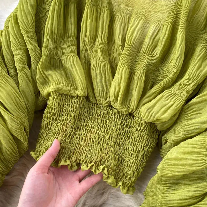 Chiffon blouse in lime green with puff sleeves and a smocked hem